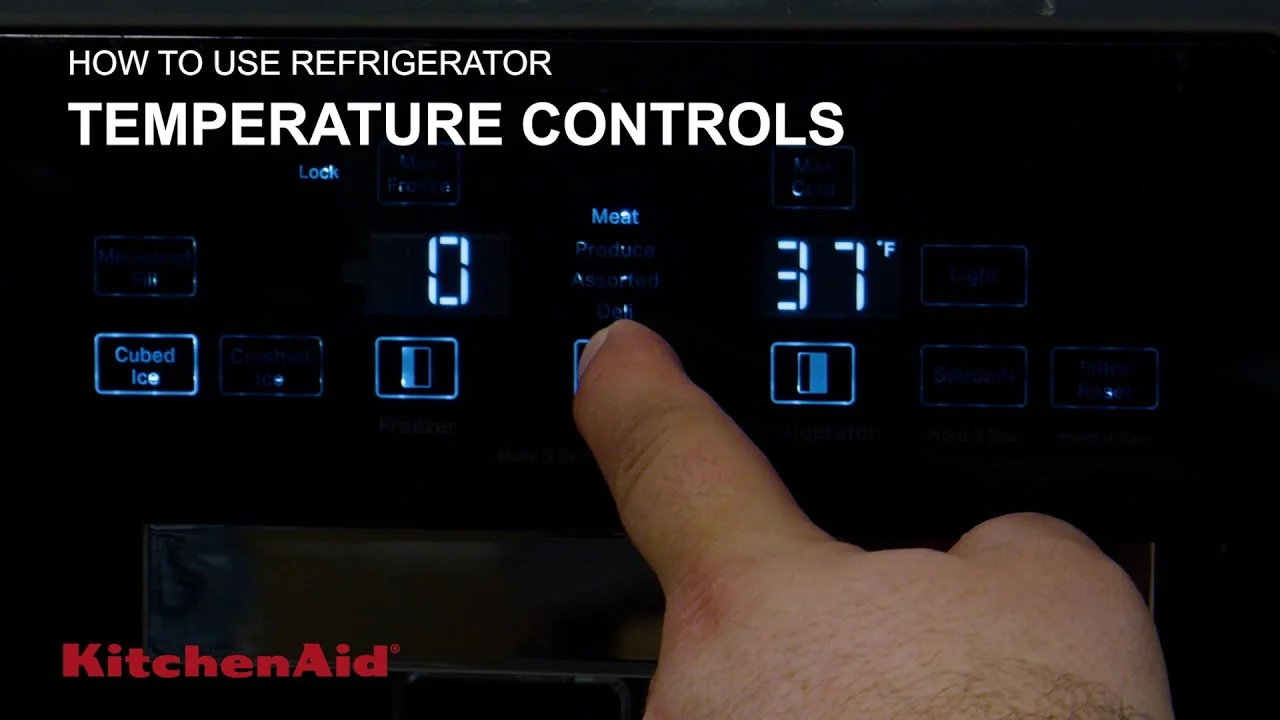 Finger using a refrigerator digital control panel with temperature and reset controls